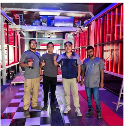 Installation team inside an illuminated JetWash wash bay